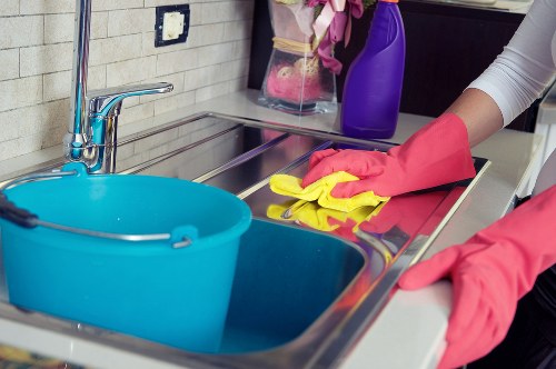 Professional cleaner preparing a kitchen during move-in cleaning in W1S